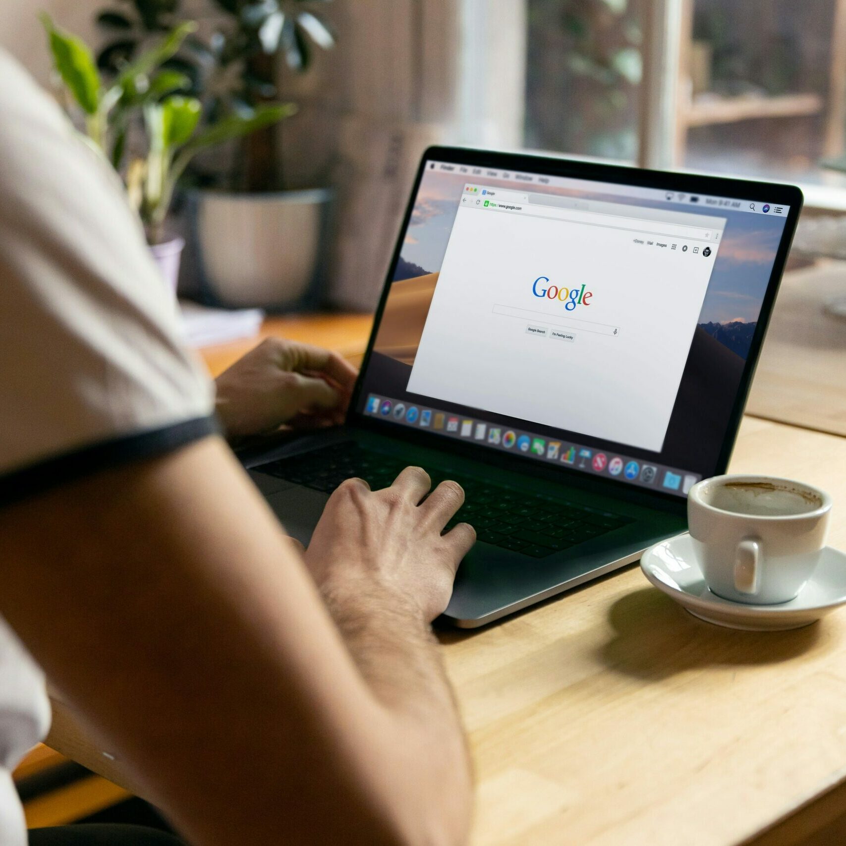 man typing on a laptop